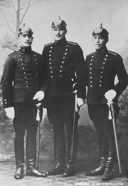 Tre män i uniform. 