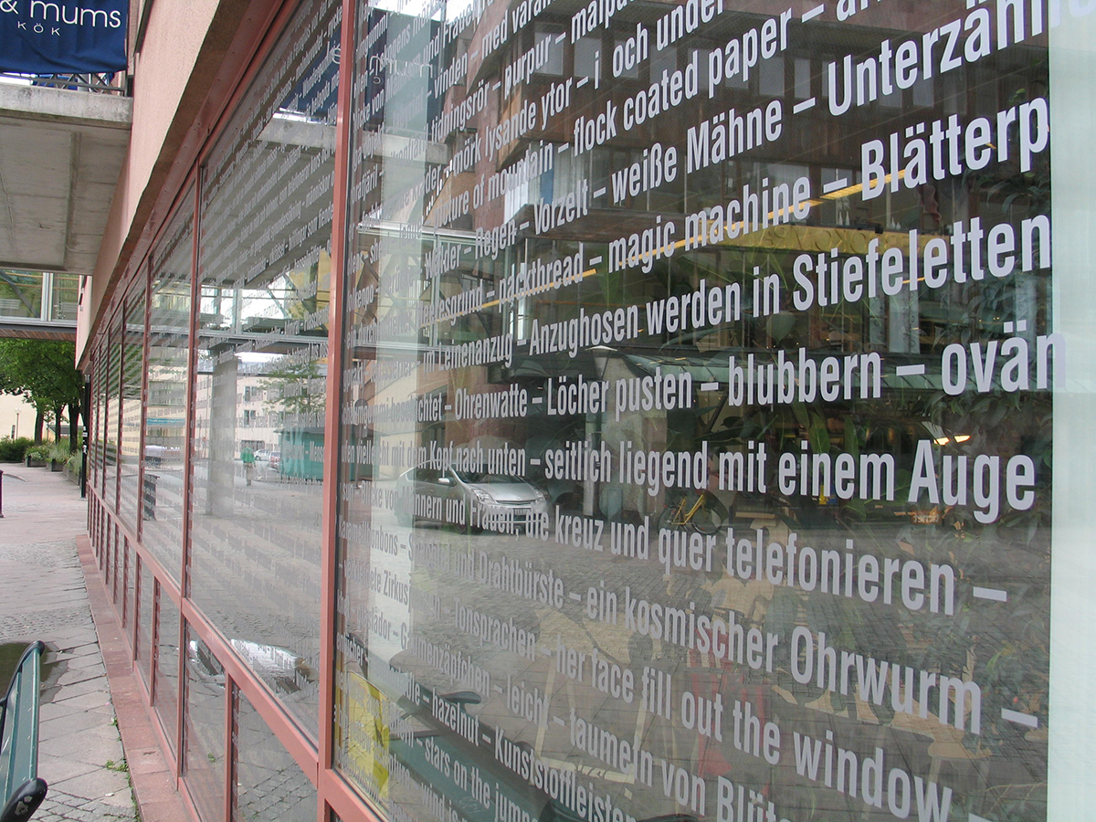 Bibliotekets glasfönster är fyllda med vita bokstäver som bilar olika ord.