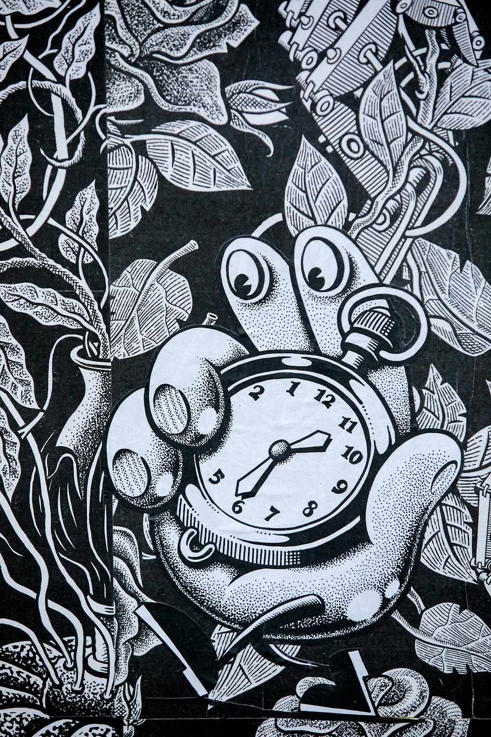 An illustration of a hand holding a clock. A pattern of leaves is visible behind. Everything is drawn in black and white.